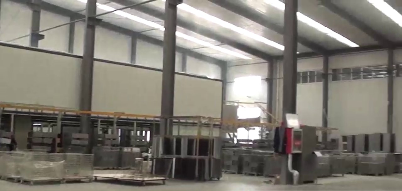 Cabinet bodies hanging on automatic powder-coat conveyor